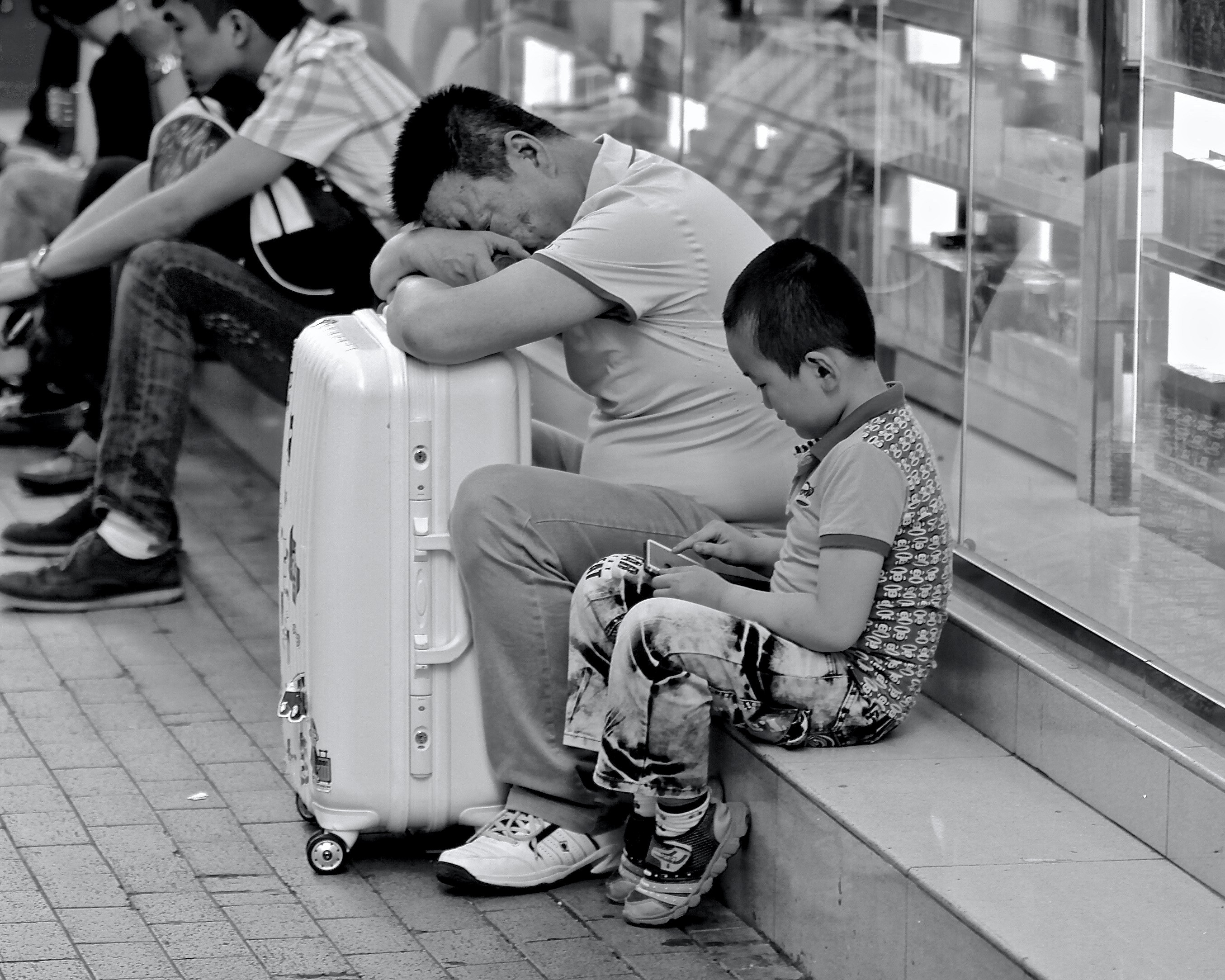 Tired salesman with son, storefront along Argyle Street, 2015
